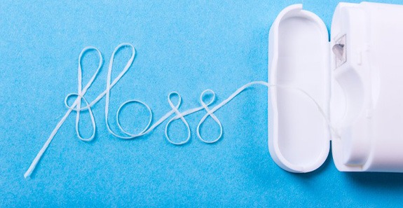 Dental floss spells “floss” in cursive