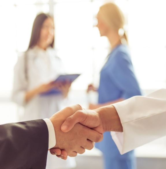 Two medical professionals shaking hands