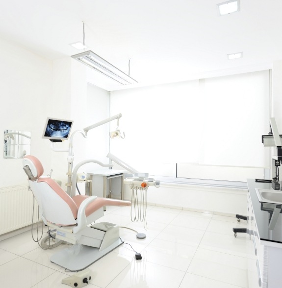 Dental treatment room with white walls and large window