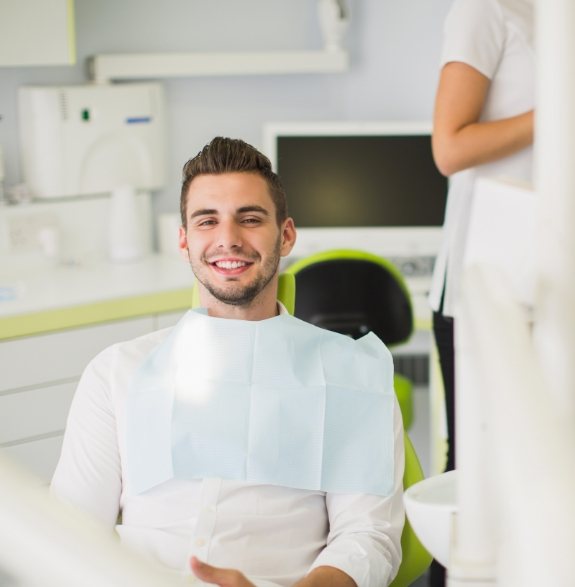 Smiling young man sitting in dental chair