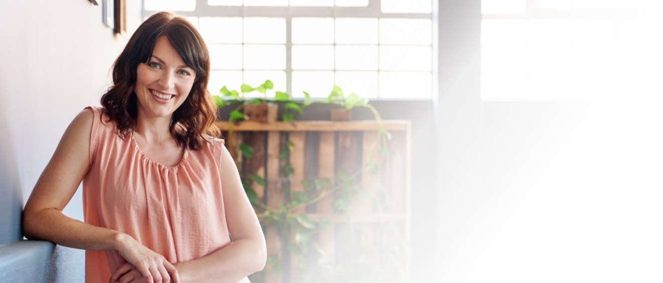 Brunette woman smiling with dental implants in Vista