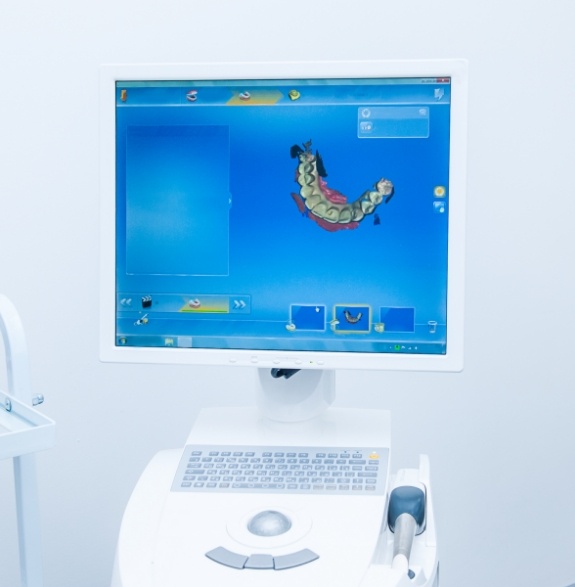 Digital model of row of teeth on computer monitor in dental office