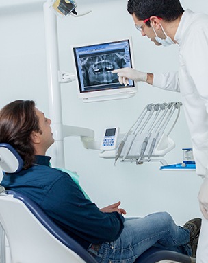 Dentist showing patient x-rays