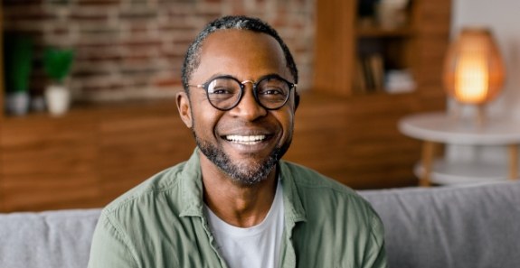 Smiling older man sitting on couch