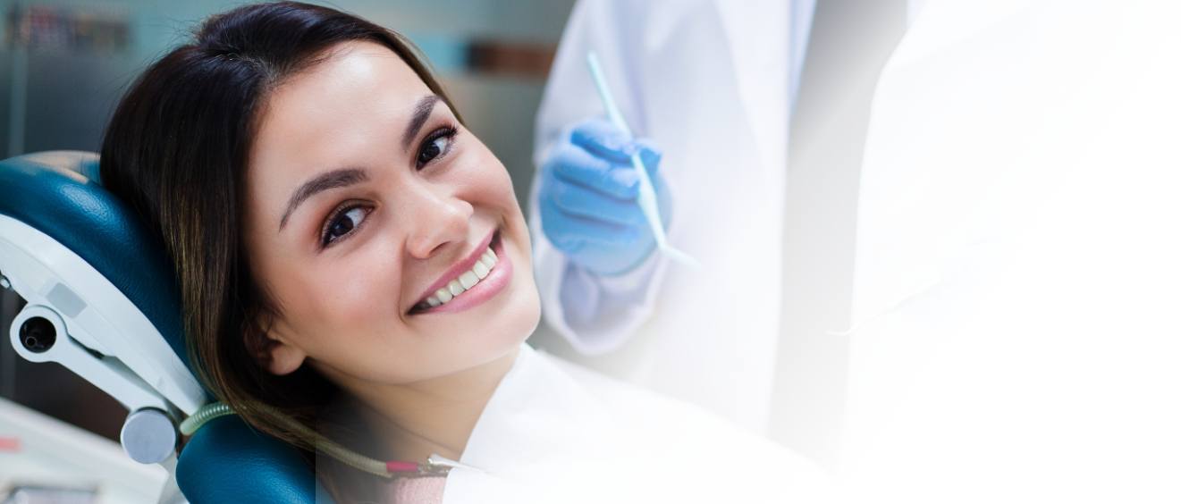 Young woman smiling in dental chair before scaling and root planing in Vista