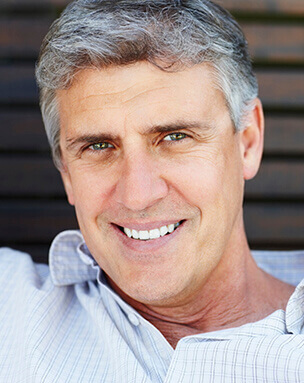 Man with healthy smile after surgical periodontal treatment